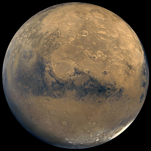 global view of the planet Mars, revealing surface features such as craters, with the dark of space in the background