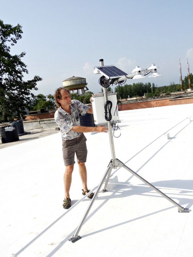 Scientist setting up equipment on a cool roof