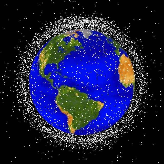 A computer-generated graphic of space debris currently being tracked in low-Earth orbit. Thousands of white dots represent the space debris and are concentrated in certain areas, such as the polar latitudes. Only 5 percent of the dots are active satellites. 