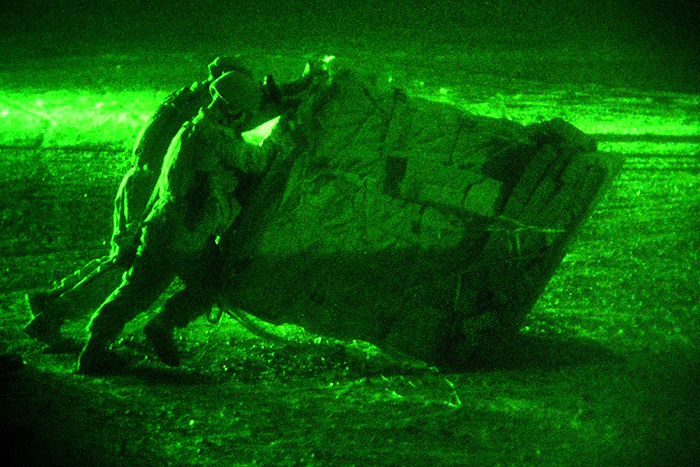 night-vision goggles view of soldiers, with infrared (hear) also appearing in view