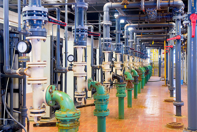 Photo taken inside of a water treatment plant showing piping 