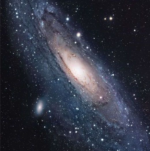 The Andromeda Galaxy displays a central, luminous bulge surrounded by a disk of radiating spiral arms.