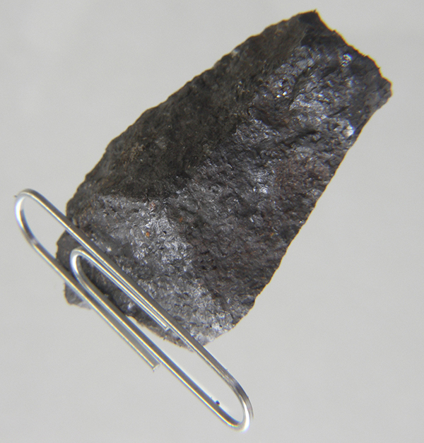 a paperclip magnetically clinging to a lodestone