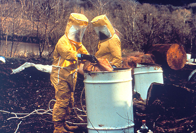 workers wearing personal protective equipment while handling hazardous materials