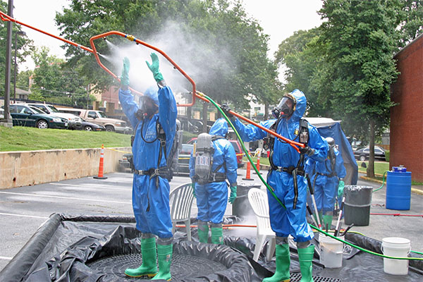  responders practicing using a decontamination station