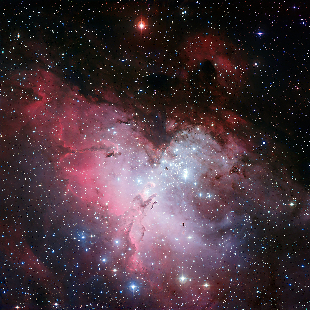 Eagle Nebula, a colorful collection of cosmic gas ad dust, seen amidst a field of stars