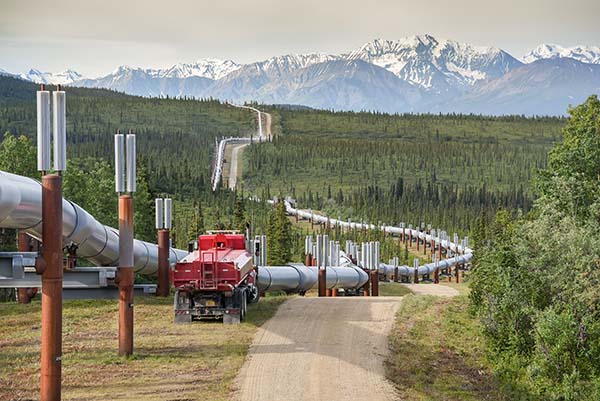 Trans-Alaska pipeline close up with maintenance truck